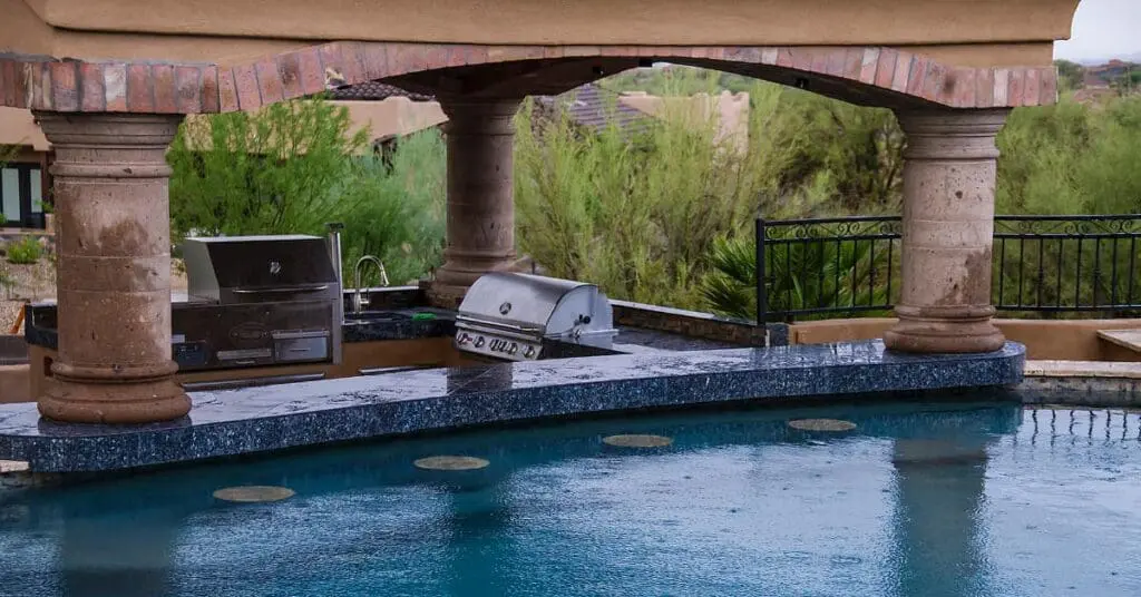 pool with swim up bar and sunken outdoor kitchen by Scottsdale pool builder