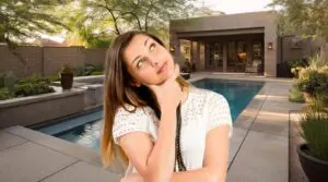 pool in background, young woman thinking, concept of how to choose the right pool builder