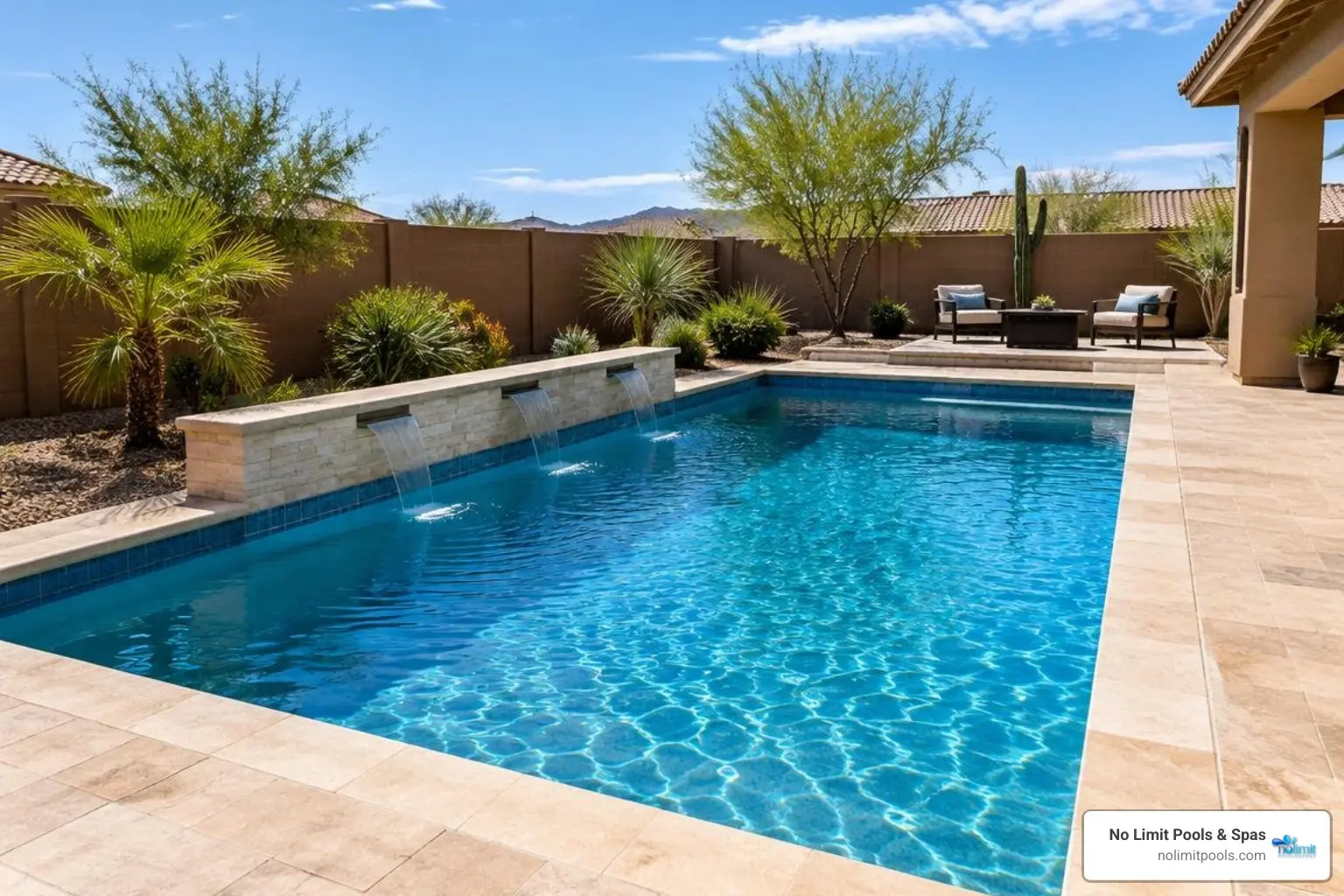 Custom in-ground pool with travertine decking in an Arizona backyard
