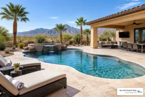 Wide view of a travertine pool patio with lounge seating and outdoor living space